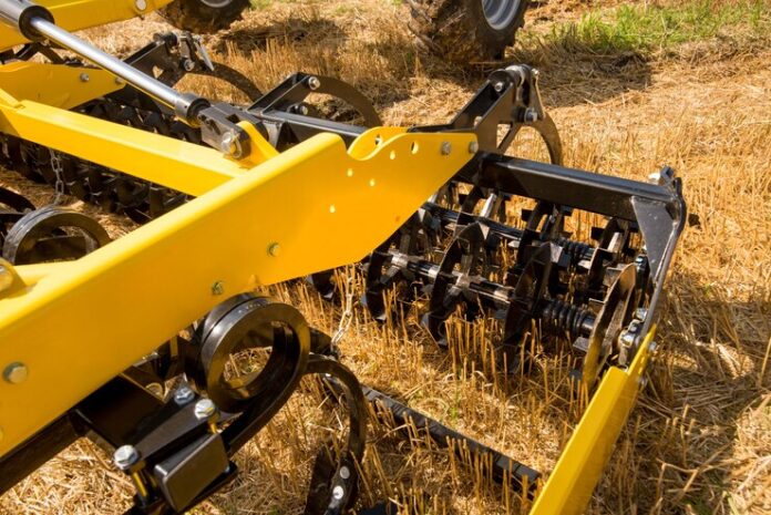 cultivator-work-close-up-disc-harrow-field-background